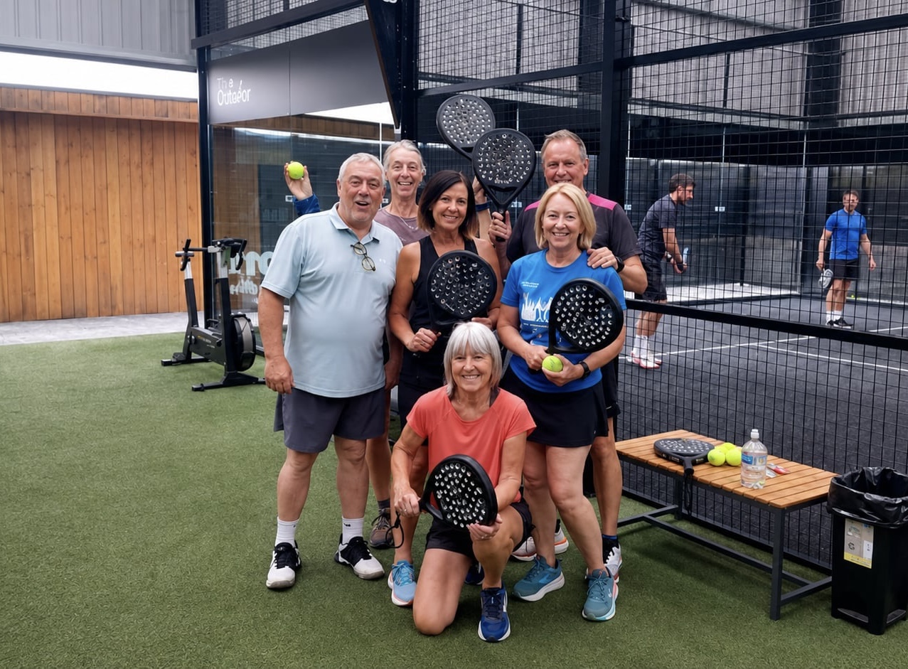 Steve, The Padel Guy, a padel coach in Newark-on-Trent, smiling on court with his racket